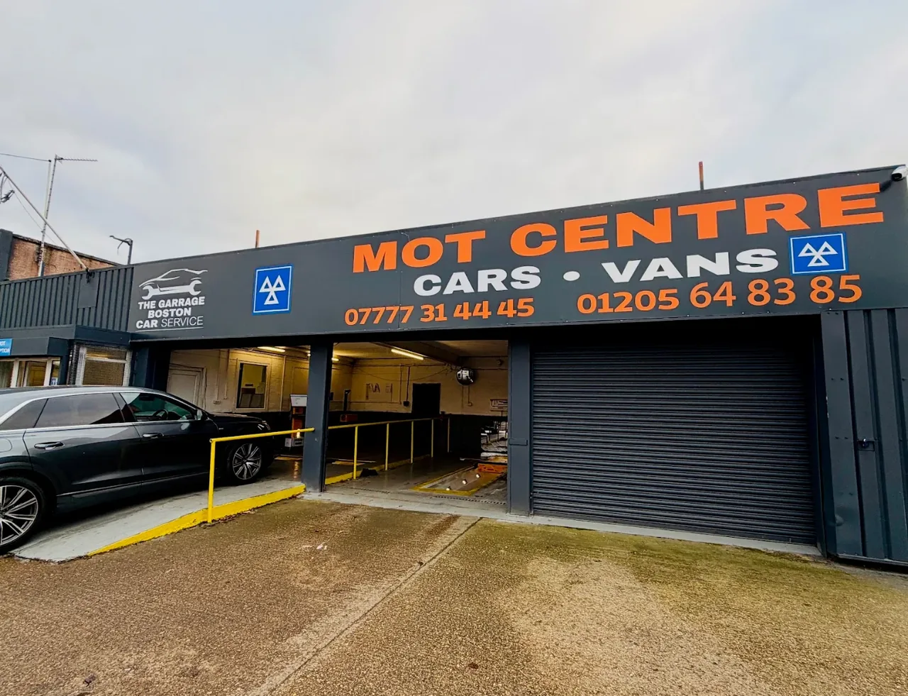 The Garage Boston shopfront on Nelson Way, showing the MOT centre signage for cars and vans